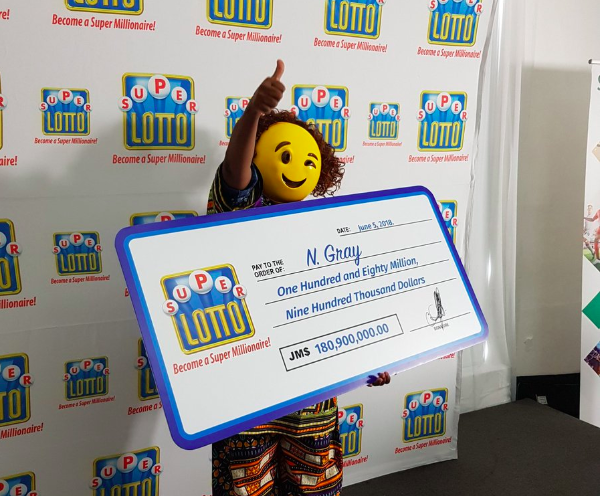 $1 million lottery winner picks up check in emoji mask